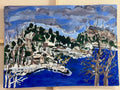 An expressive landscape painting depicting a coastal village with deep blue water, rocky shorelines, leafless trees, and a cloudy sky, shown on a light-colored wooden surface.